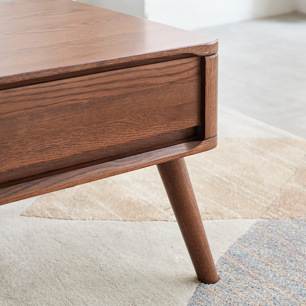 Detail view of the oak wood coffee table leg and corner design, showcasing its sturdy and stylish build.