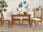 Farmhouse dining table set for 4 with upholstered chairs in a modern dining room, featuring wood frame and neutral tones.