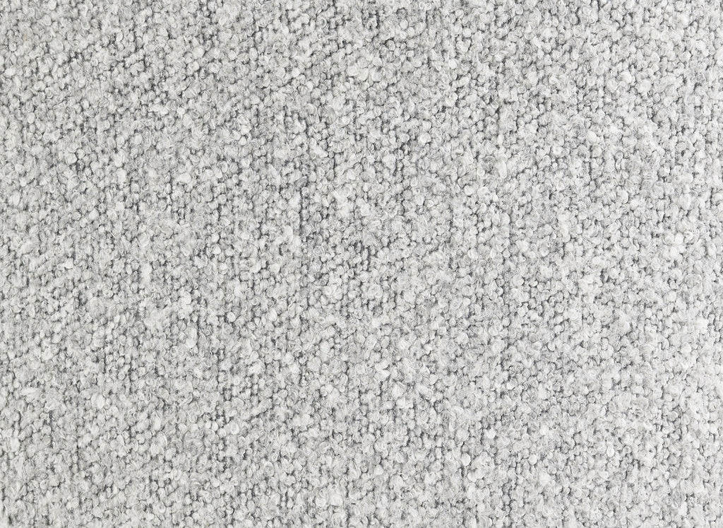 Close-up texture of the gray boucle fabric used in the upholstered accent chair, emphasizing its soft and durable material.