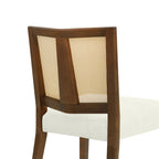 Detail of the backrest from an angle, showing the rattan weave and the dark wood frame of the mid-century dining chair.