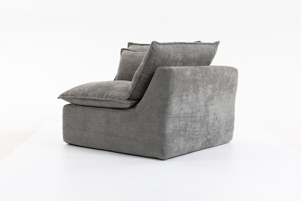Rear side view of a single Cloud Couch modular seat in grey velvet, highlighting its clean, modern design.