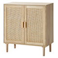 Natural wood buffet cabinet with two rattan-paneled doors, wooden handles, and tapered legs in a modern boho style.
