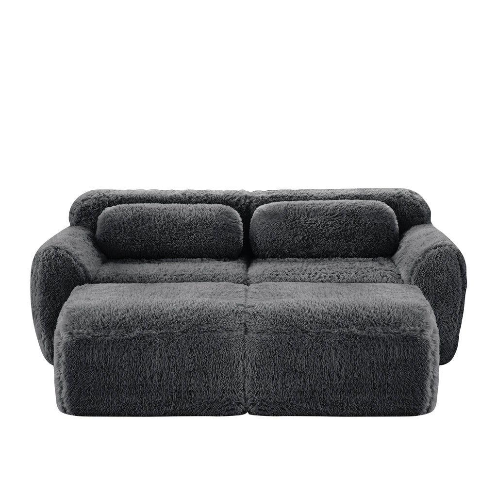 Front view of Plush Modular Sofa Dark Grey with ottoman and pillows, highlighting its cozy plush fabric and modular layout.