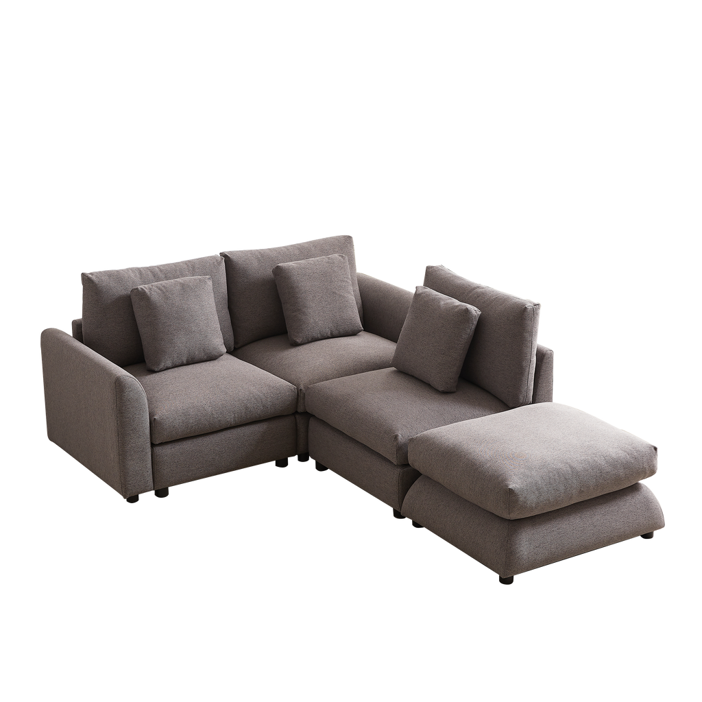 L-shaped modular sofa with ottoman, upholstered in gray fabric, featuring three seat cushions and four pillows for customizable comfort.