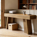 Rustic wooden console table with a thick top and angled block legs, styled as a minimalist entryway or sofa desk.