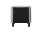Back view of Cleo Gray Boucle Nightstand with black fabric panel and wooden legs. Stylish and functional bedroom furniture design.