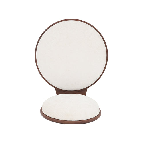 Close-up of a single beige dining chair seat and backrest detached from frame. Showcases soft fabric and circular design.