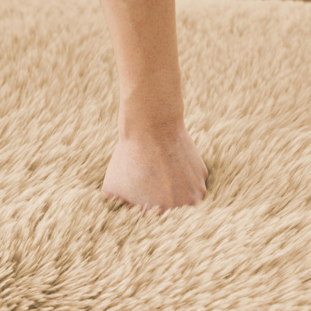 Hand pressing into plush fabric of modular sofa, showcasing the softness and high-density cushioning of the upholstery.