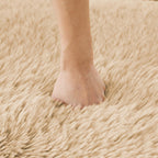 Hand pressing into the plush surface of the L-shaped modular sofa, demonstrating its soft and ergonomic cushioning.