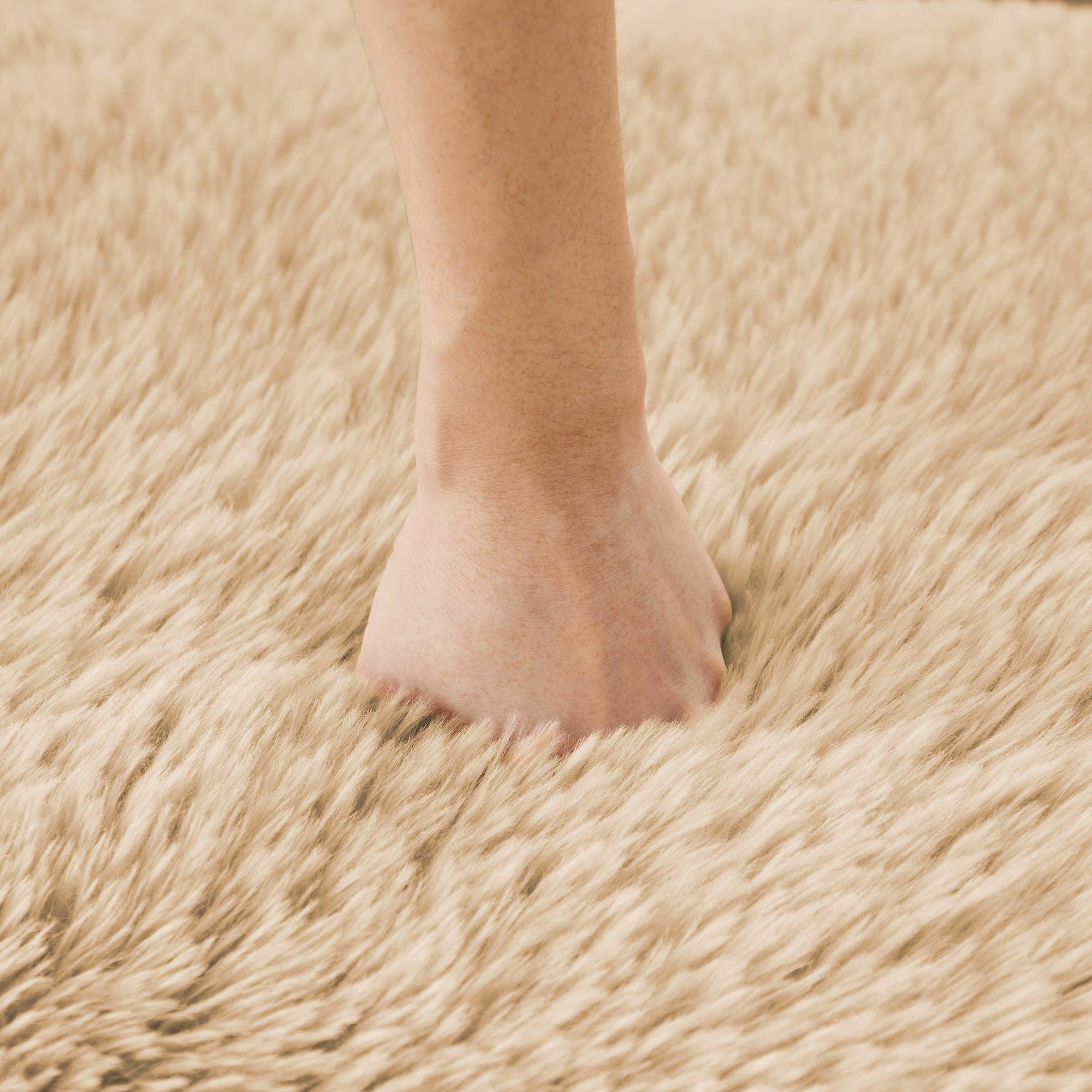 Hand pressing into the plush surface of the L-shaped modular sofa, demonstrating its soft and ergonomic cushioning.
