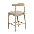 Rear angled view of modern counter stool with pebble fabric seat and sculpted rubberwood frame, blending comfort and style.