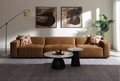 Contemporary modular sectional sofa in chocolate suede, featuring tufted cushions and two patterned toss pillows.