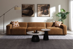 Contemporary modular sectional sofa in chocolate suede, featuring tufted cushions and two patterned toss pillows.