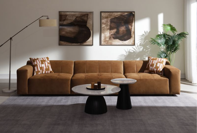 Contemporary modular sectional sofa in chocolate suede, featuring tufted cushions and two patterned toss pillows.