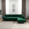 Modern right-facing L-shaped velvet sectional sofa in forest green with gold metal legs, set in a living room.