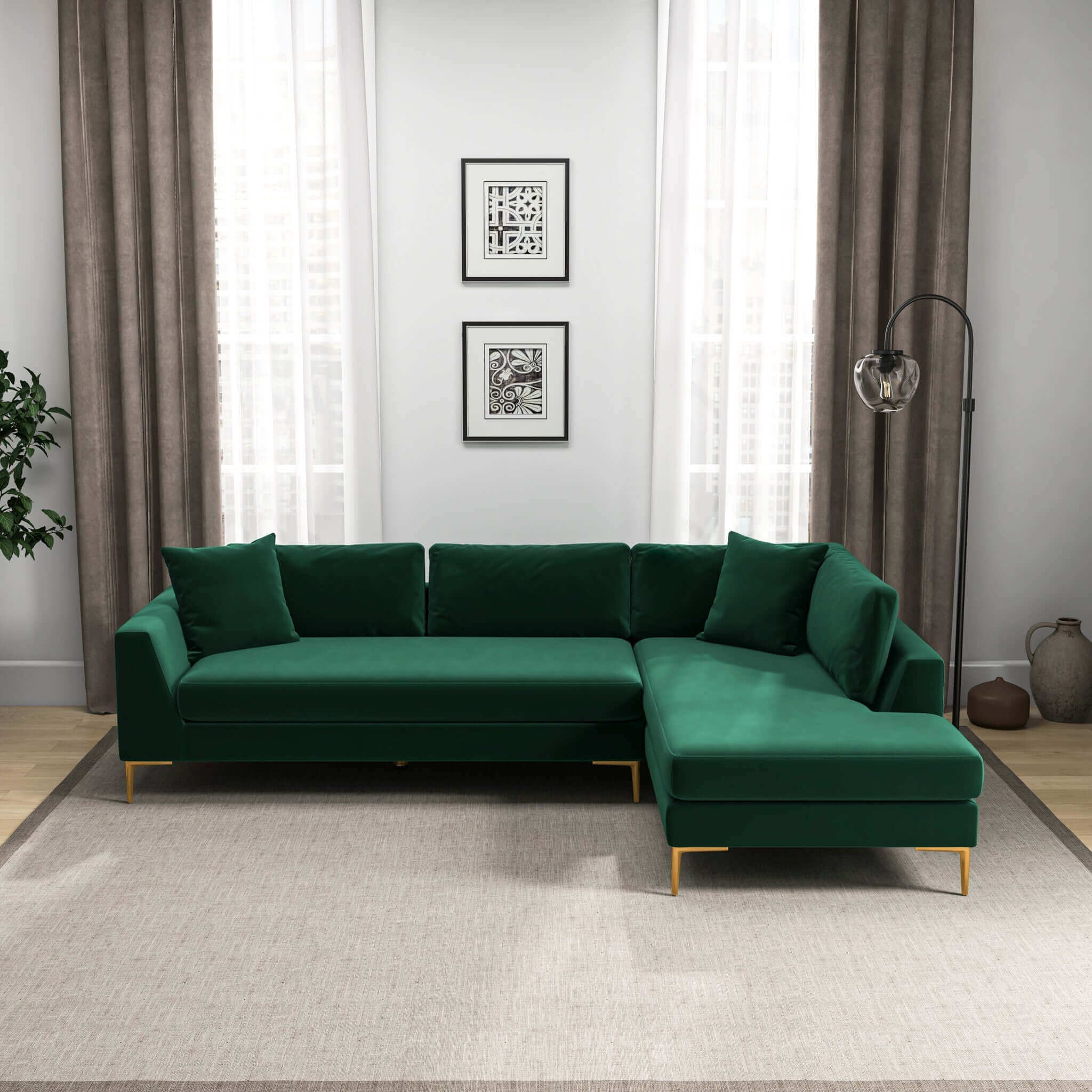 Modern right-facing L-shaped velvet sectional sofa in forest green with gold metal legs, set in a living room.