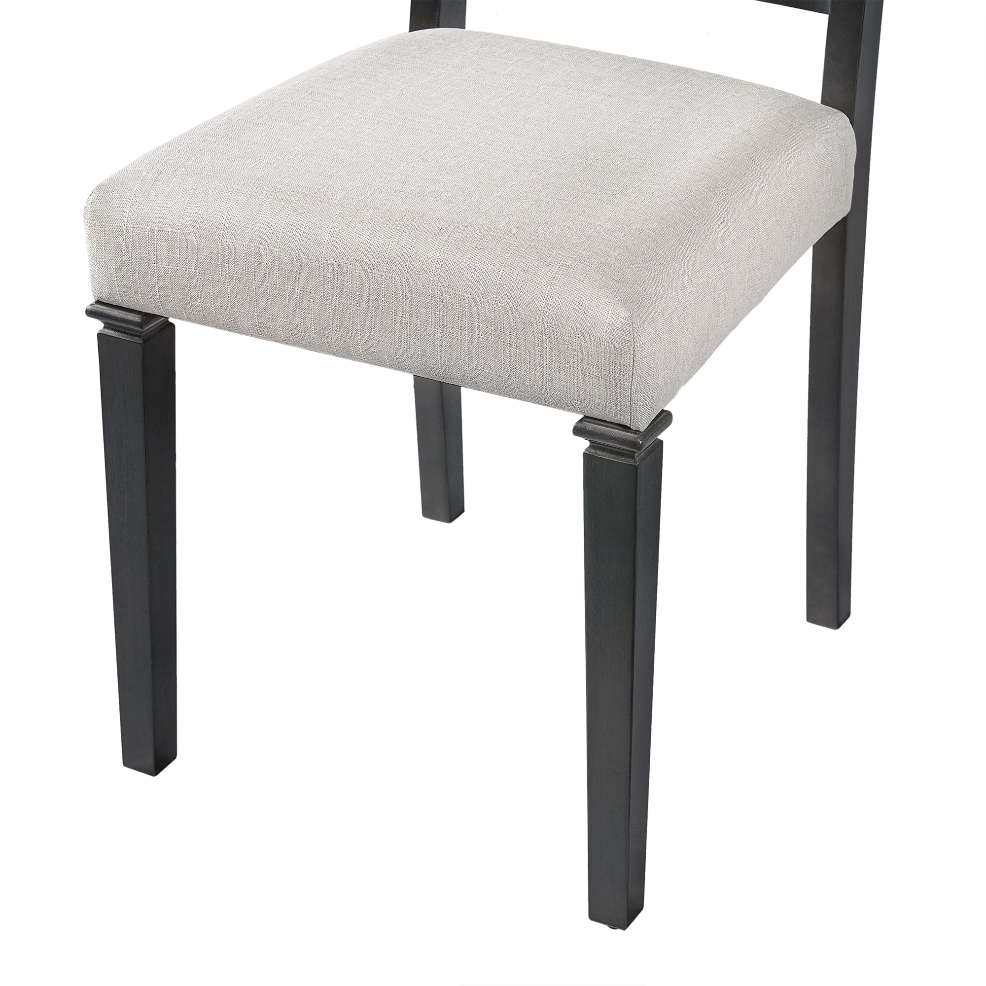 Close-up of retro dining chair seat with beige upholstery and black wooden legs, designed for comfort and durability in dining rooms.