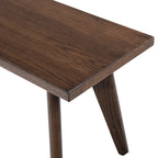 Close-up of Capri bench top showcasing dark brown red oak wood grain. Smooth finish highlights handcrafted quality.
