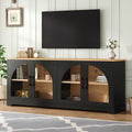 Two-tone farmhouse media console with black frame, natural wood top, and semi-arched glass doors for 70-inch TVs.