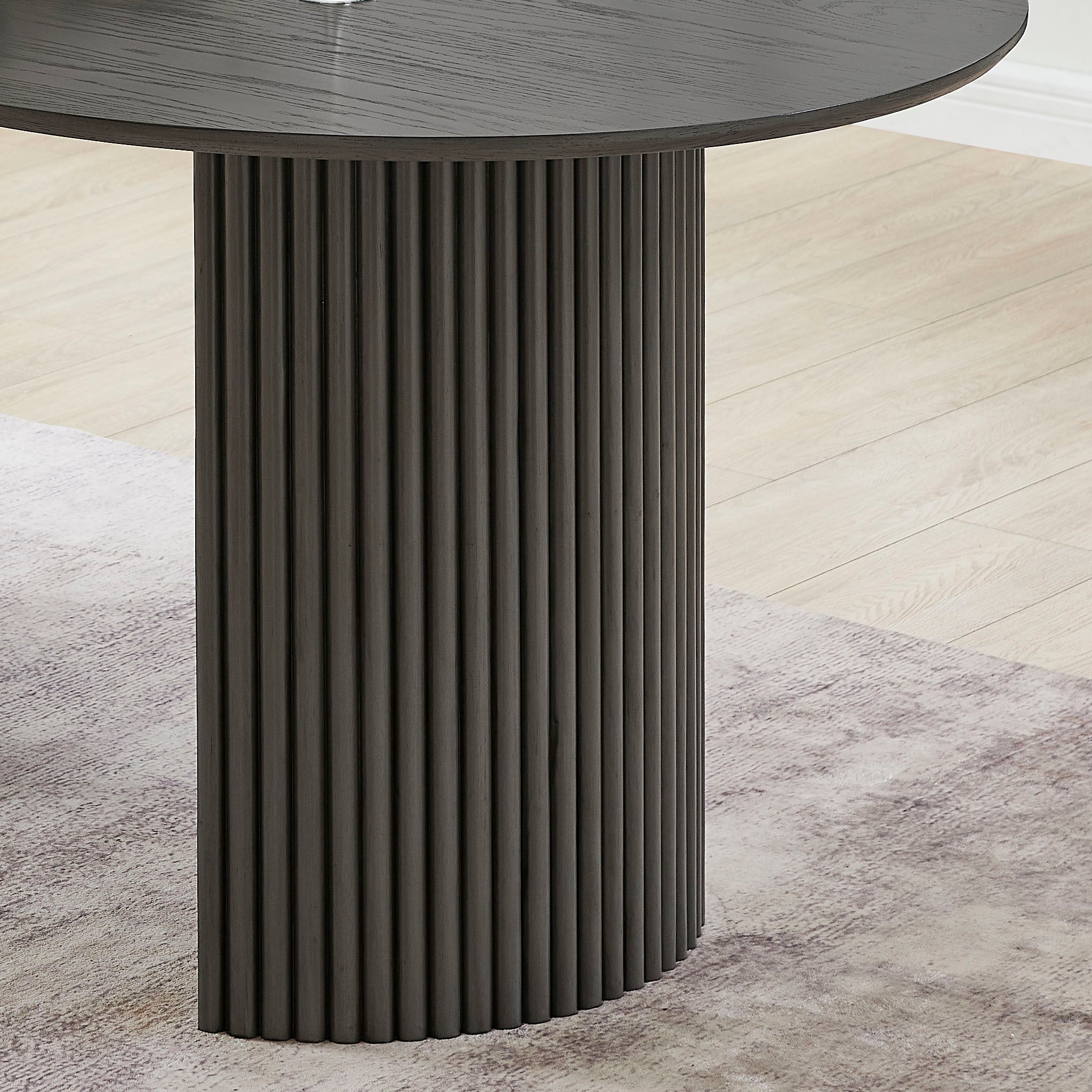 Close-up of the fluted pedestal base on the gray oak dining table from the Valencia 7-piece oval dining set.