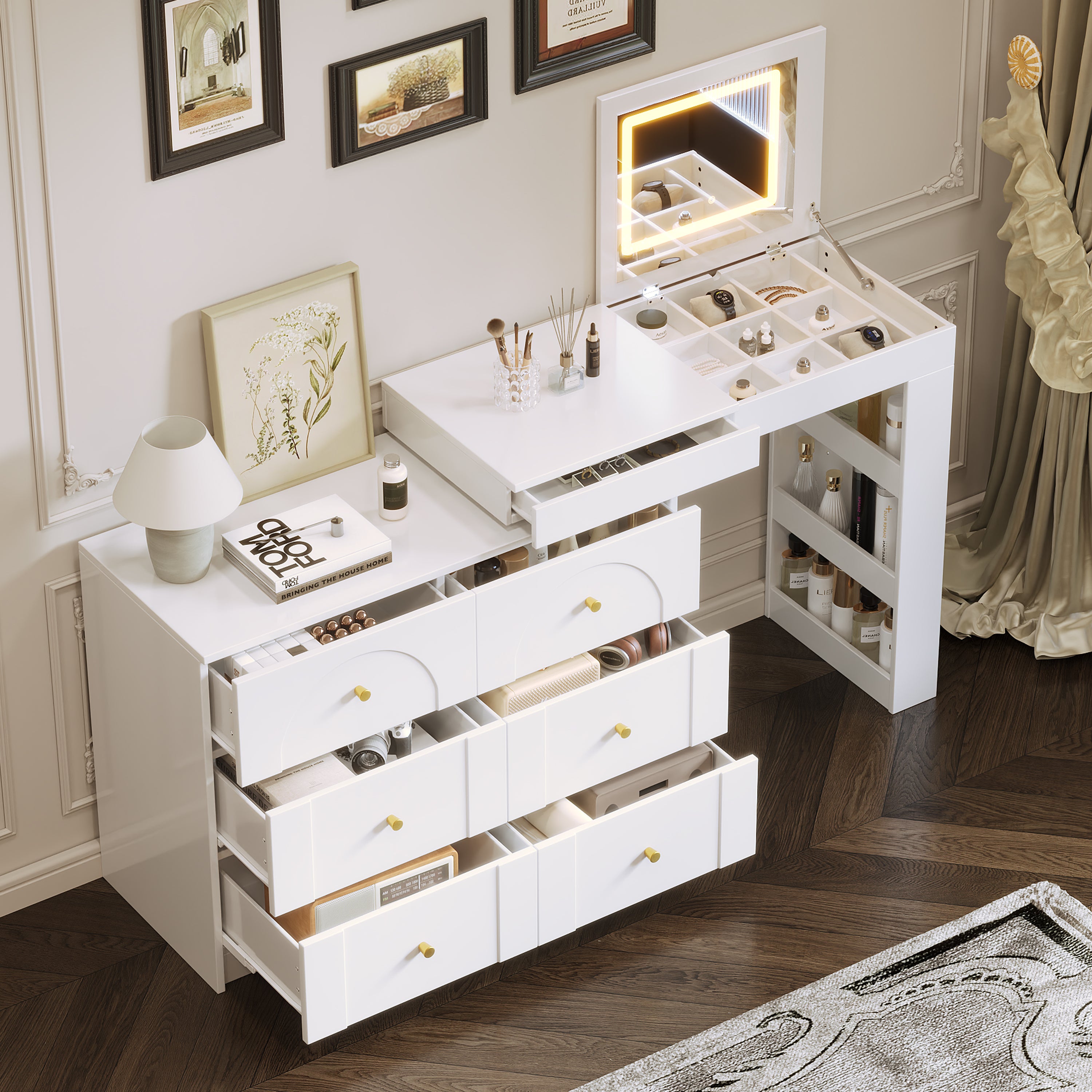 Top view of vanity desk with mirror and lights, open drawers and compartments displaying organized makeup and jewelry storage.