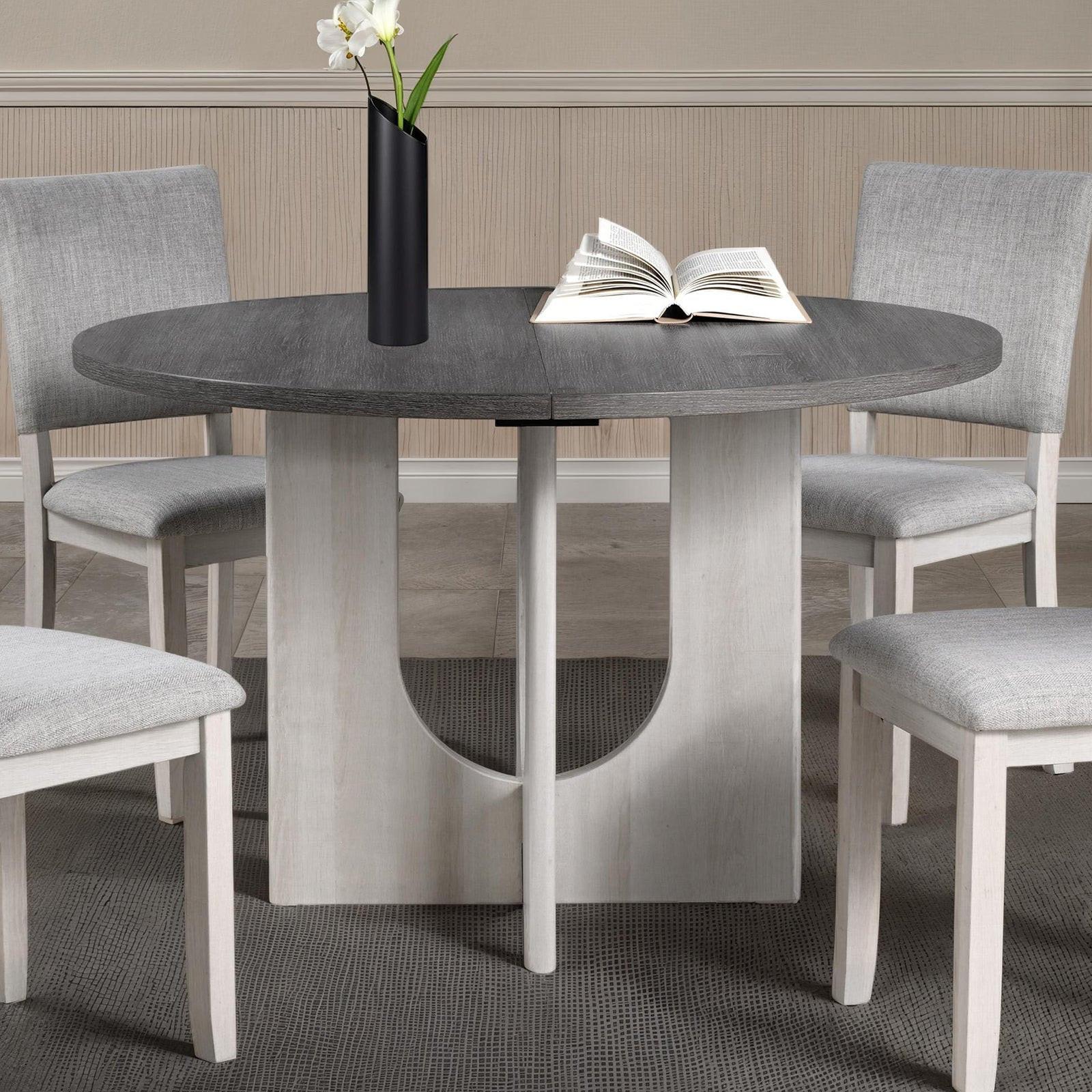 5pc dining set with gray upholstered chairs and round table.