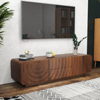 Walnut mid-century TV console with unique spiral wave texture, two drawers, and storage cabinet under a wall-mounted TV.