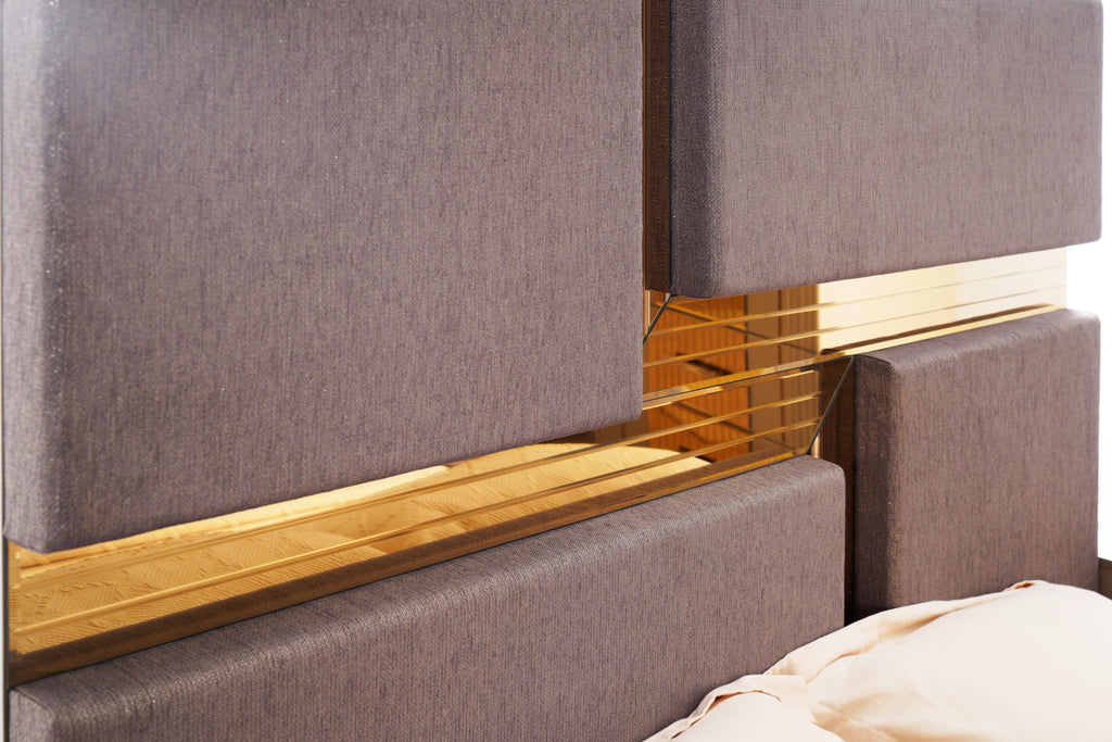 Close-up of Lorenzo Queen Bed headboard showing intersecting gray panels and gold mirror detailing for a luxury finish.