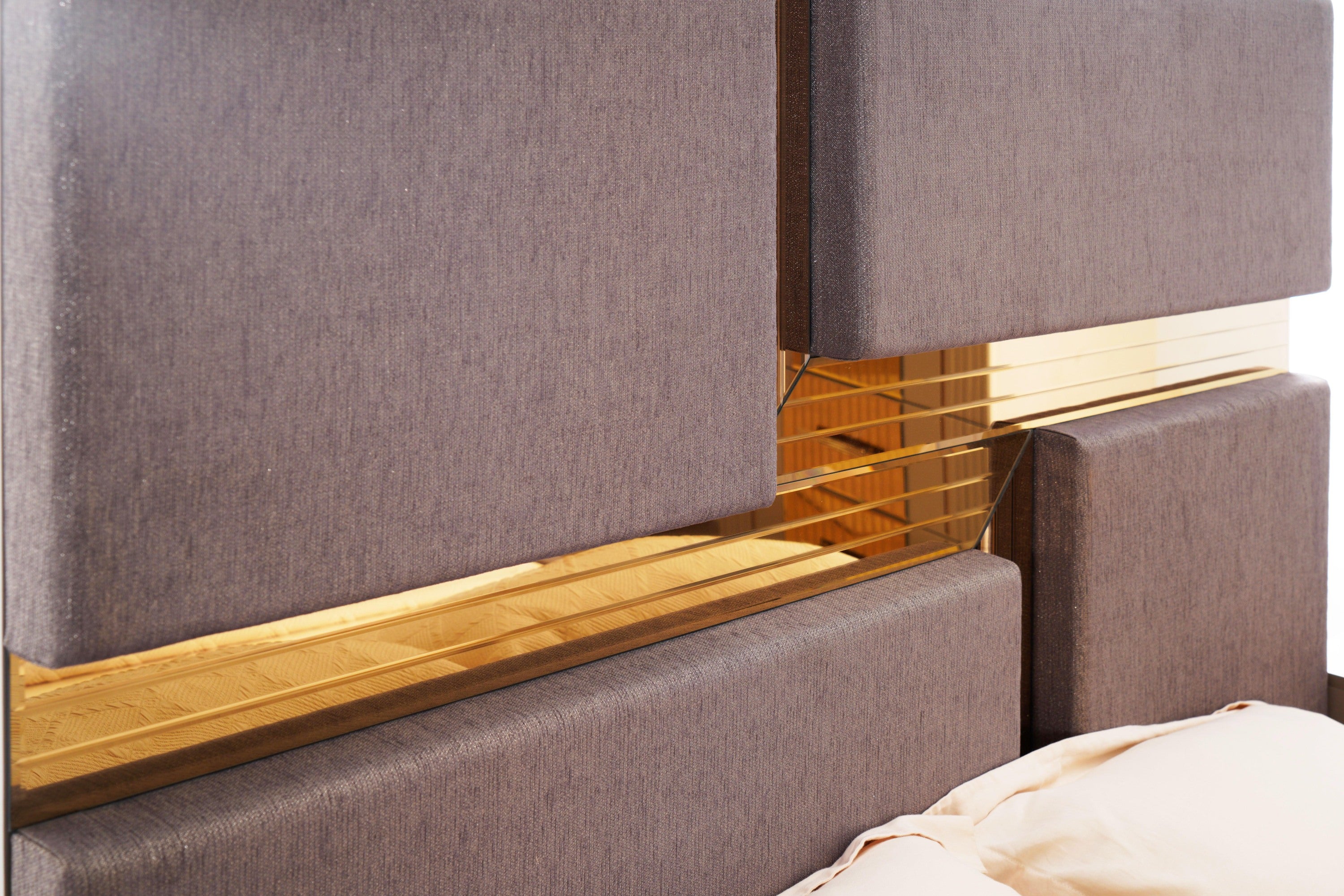 Close-up of Lorenzo Queen Bed headboard showing intersecting gray panels and gold mirror detailing for a luxury finish.
