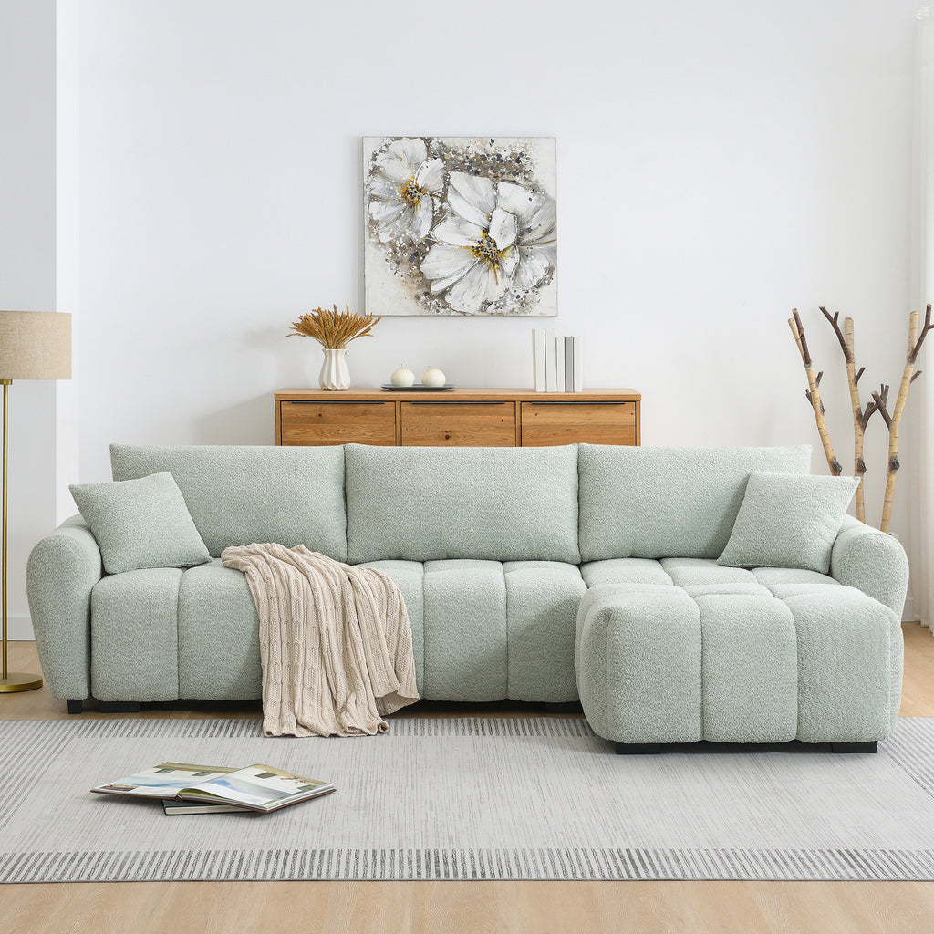 Full front view of modular sectional sofa with ottoman, featuring plush cushions and a cozy throw blanket on a neutral rug.