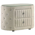 Ivory bouclé oval nightstand with two drawers, a tempered glass top, diamond-tufted sides, and crystal drawer knobs.