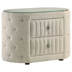 Ivory bouclé oval nightstand with two drawers, a tempered glass top, diamond-tufted sides, and crystal drawer knobs.