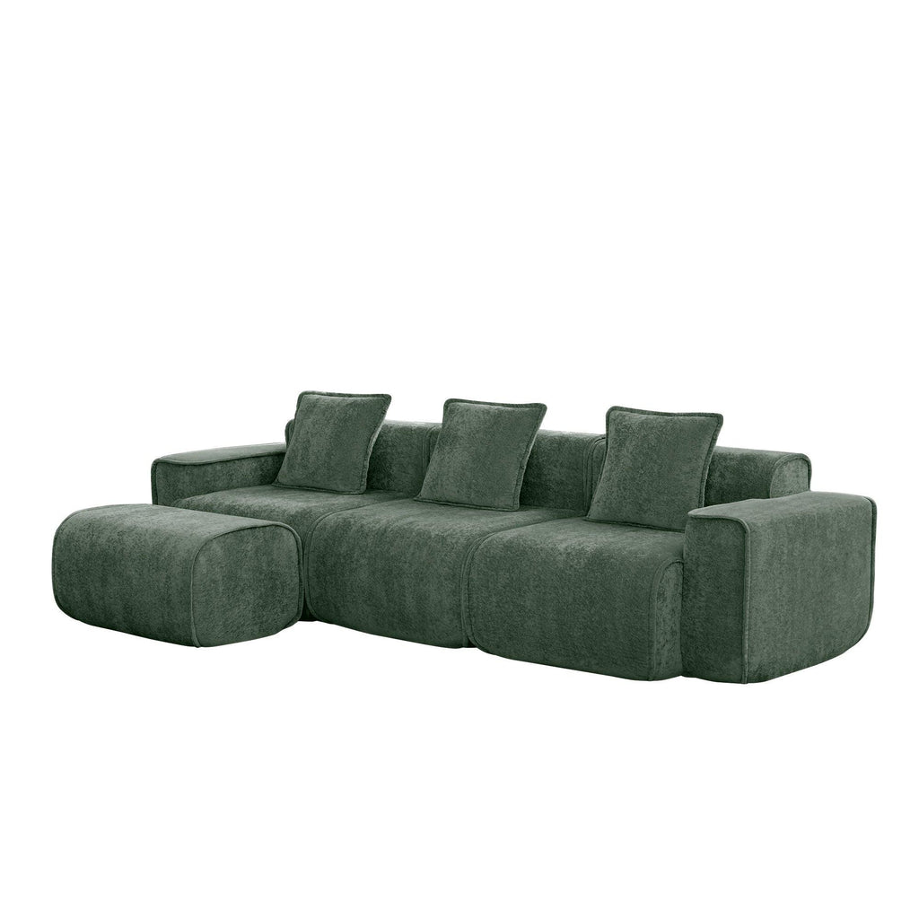 Angled view of green velvet modular sofa with L-shaped layout and ottoman, ideal for modern living spaces.