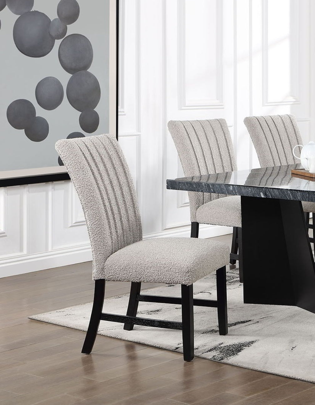 Side view of gray boucle dining chairs with vertical channel tufting, part of the Genuine Marble Dining Table Set.