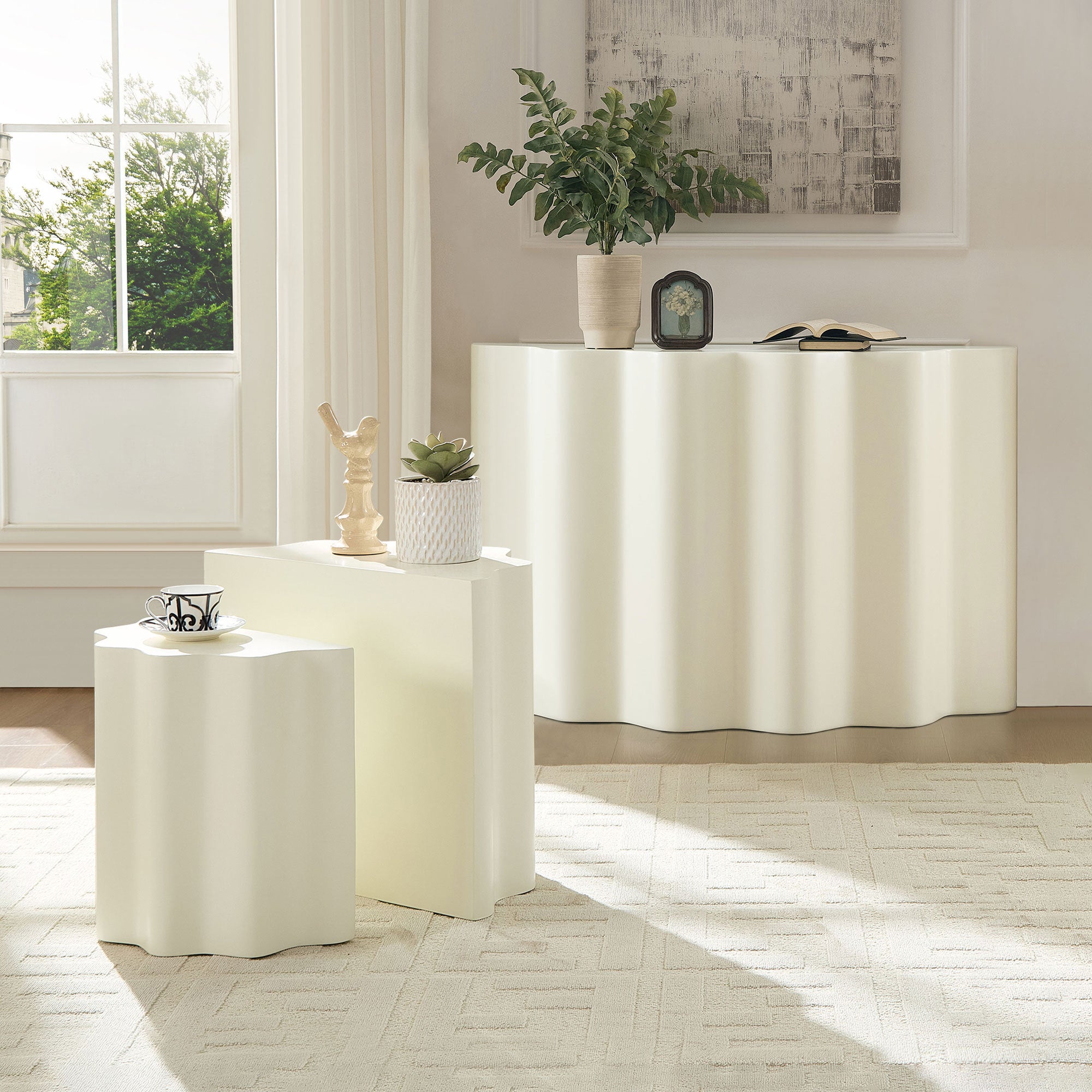 Modern cream-colored fiberglass side and console table set featuring a minimalist, wavy-edged sculptural design.