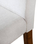 Detailed view of seat and backrest joint on rustic upholstered dining chair, showcasing durable stitching and fabric texture.