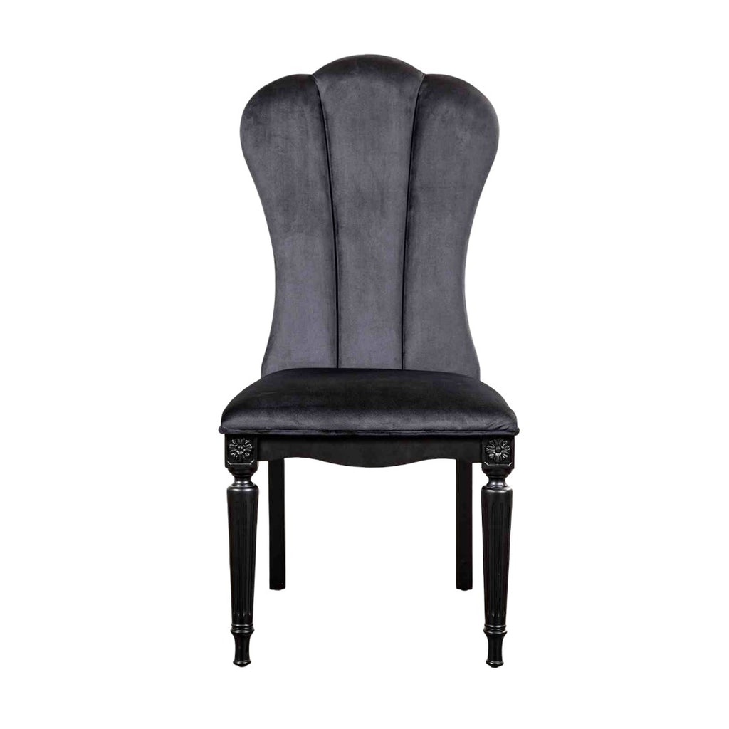 Front view of black dining room side chair featuring fluted legs and plush velvet upholstery for luxurious seating.