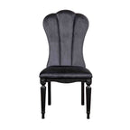 Front view of black dining room side chair featuring fluted legs and plush velvet upholstery for luxurious seating.