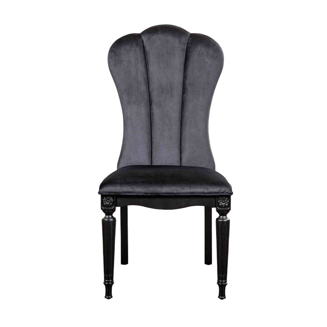 Front view of black dining room side chair featuring fluted legs and plush velvet upholstery for luxurious seating.