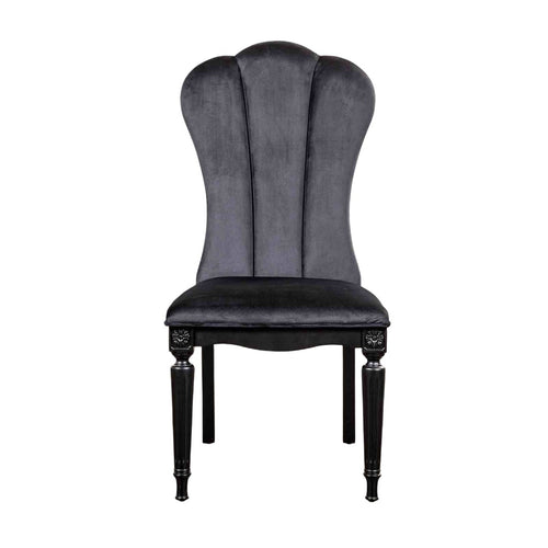 Front view of black dining room side chair featuring fluted legs and plush velvet upholstery for luxurious seating.