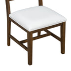 Close-up of white upholstered dining chair seat with wooden frame. Designed for comfort and farmhouse style.