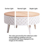 Round coffee table with white carved base and natural wood top shown under different lighting conditions to illustrate color variation.