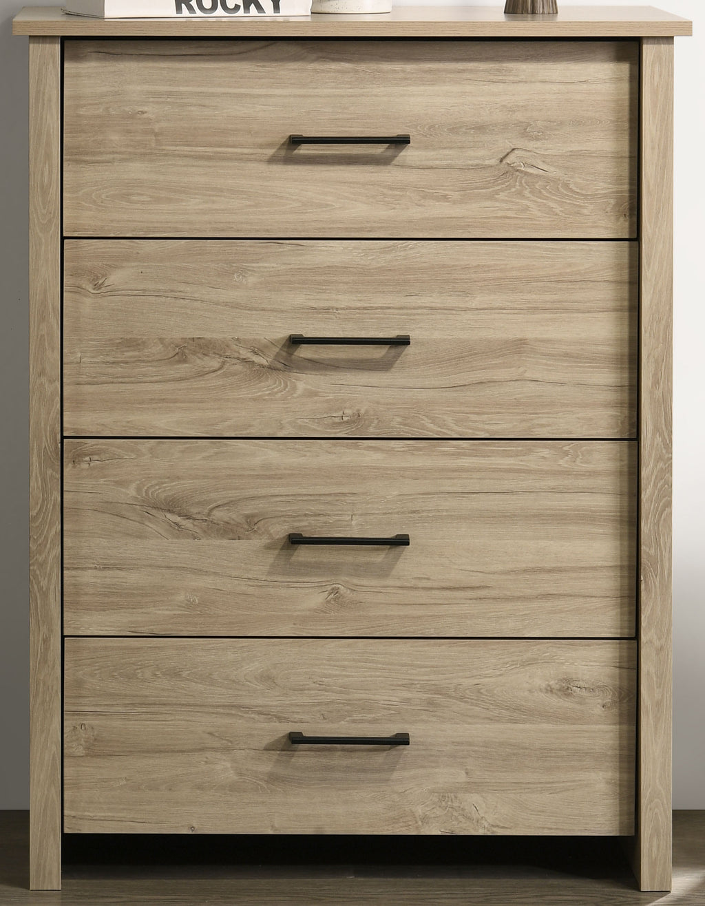 Close-up of Light Oak 4-Drawer Chest - Black Handles showing wood grain texture and sleek drawer alignment for practical storage.