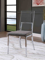 Minimalist chrome dining chair with acrylic backrest and gray cushion placed in a stylish, modern dining room.