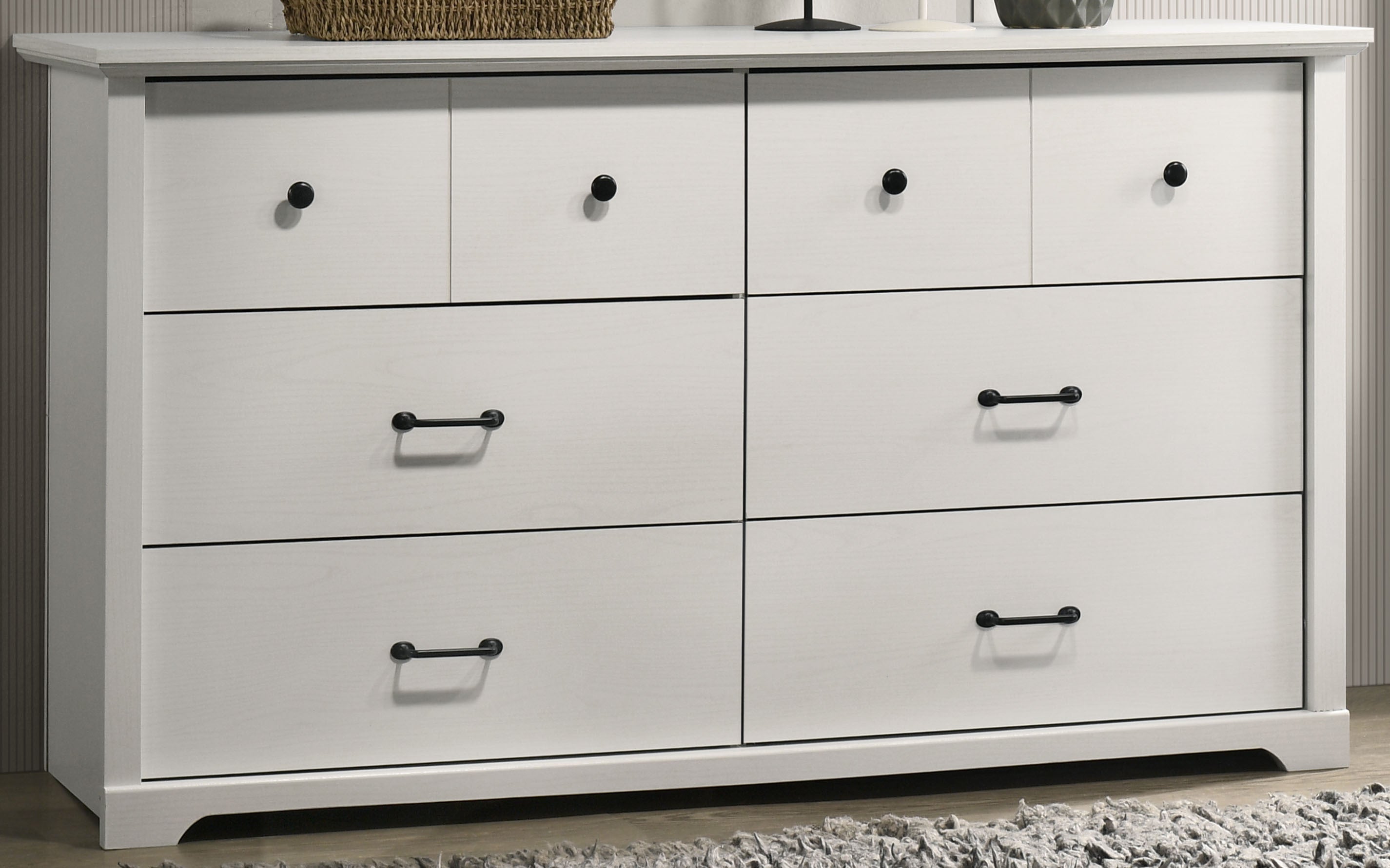 Close-up of Elara White 6-Drawer Dresser showing sleek black metal handles and smooth white finish for modern bedroom storage.