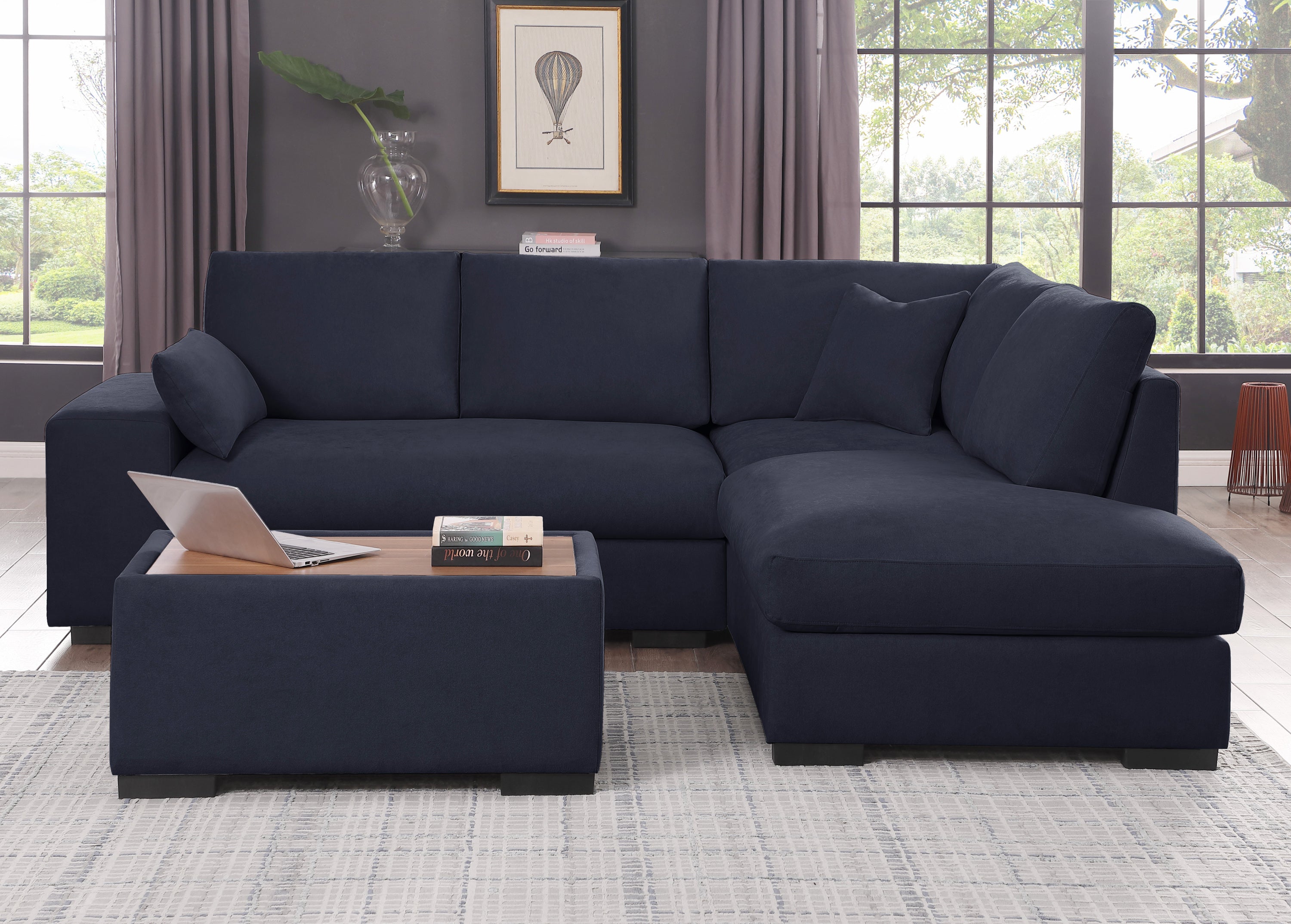 Front view of dark gray sectional sofa with ottoman. Fabric sofa with chaise and wood-top ottoman, ideal for seating 4.