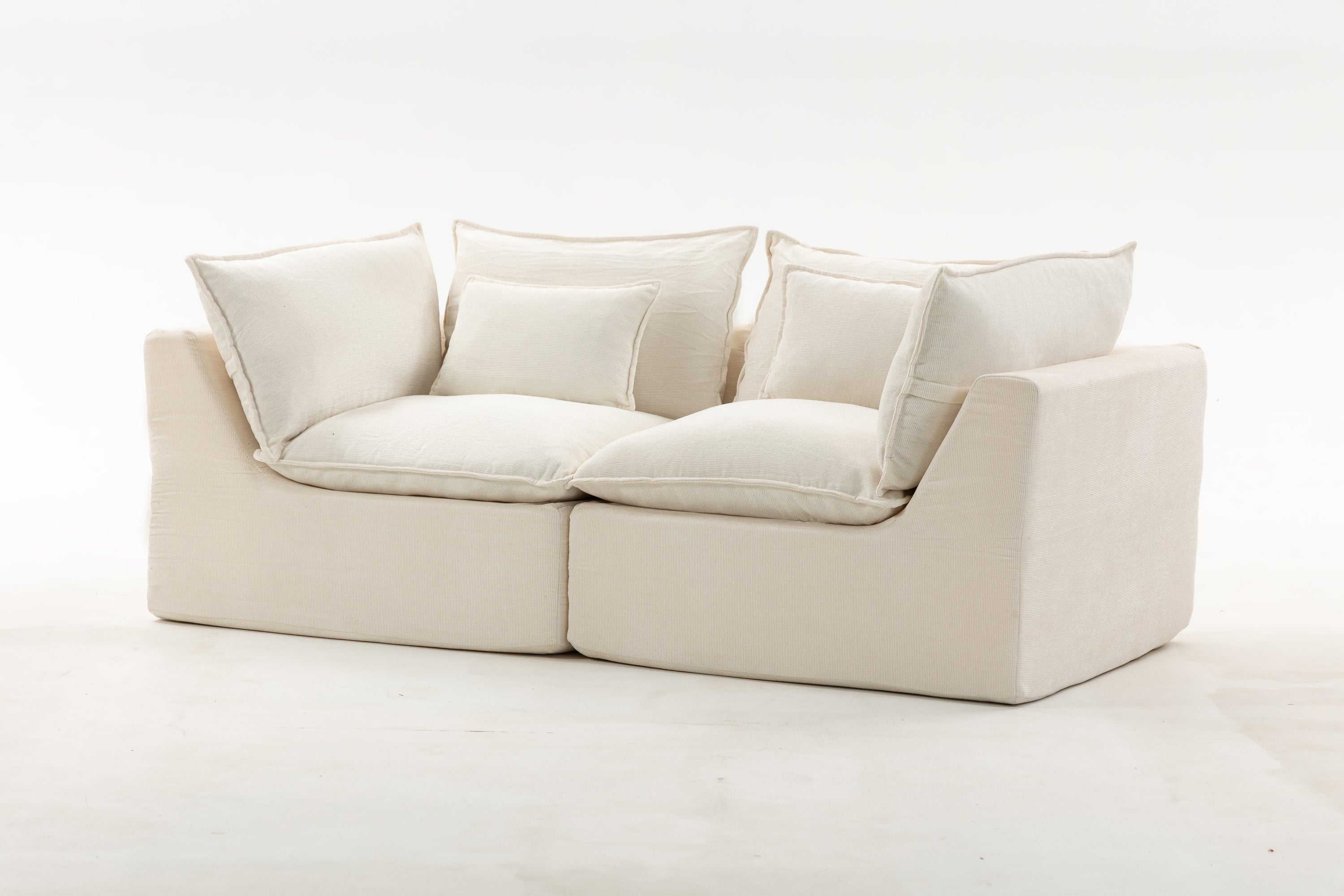 Angled view of oversized modular sectional sofa highlighting its plush velvet cushions and contemporary, modular structure.