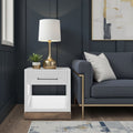 Nora End Table 22 inch in Jasmine White with drawer and shelf, styled in a dark modern living room with gold lamp and navy sofa.