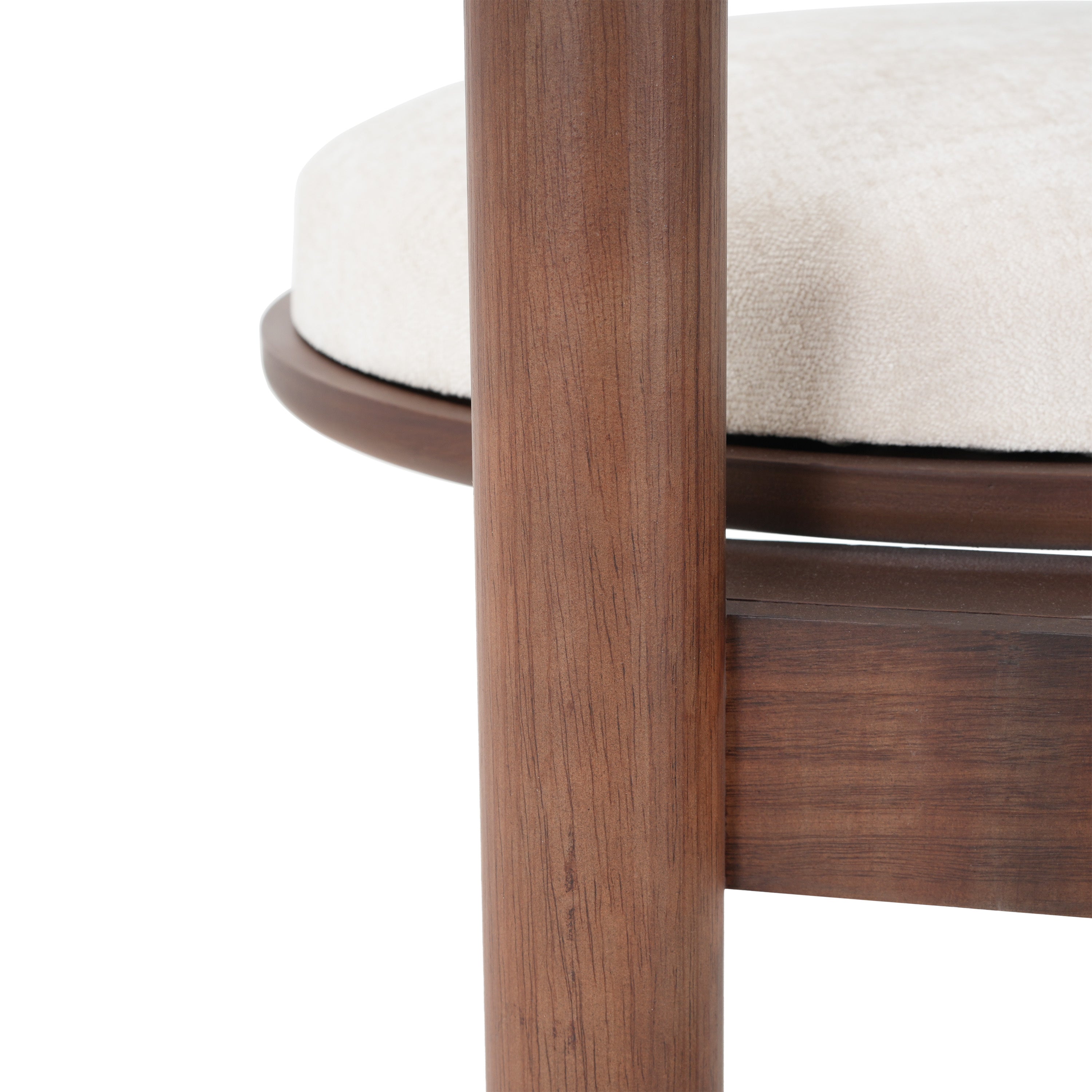Detail of chair leg and seat frame in solid wood. Emphasizes smooth finish and sturdy construction of dining chair.