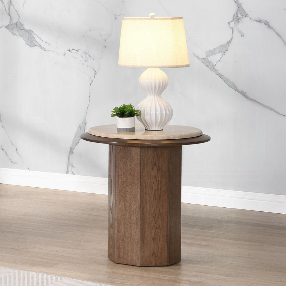Kasha Walnut Travertine End Table with round travertine top and wooden base, styled with lamp and plant in modern living room.